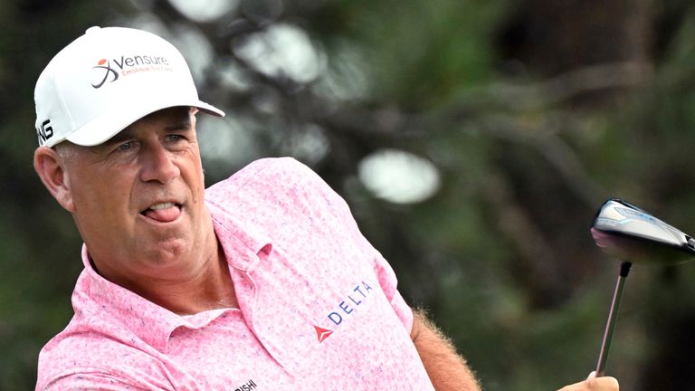 Stewart Cink watches his ball after teeing off on the 12th hole 