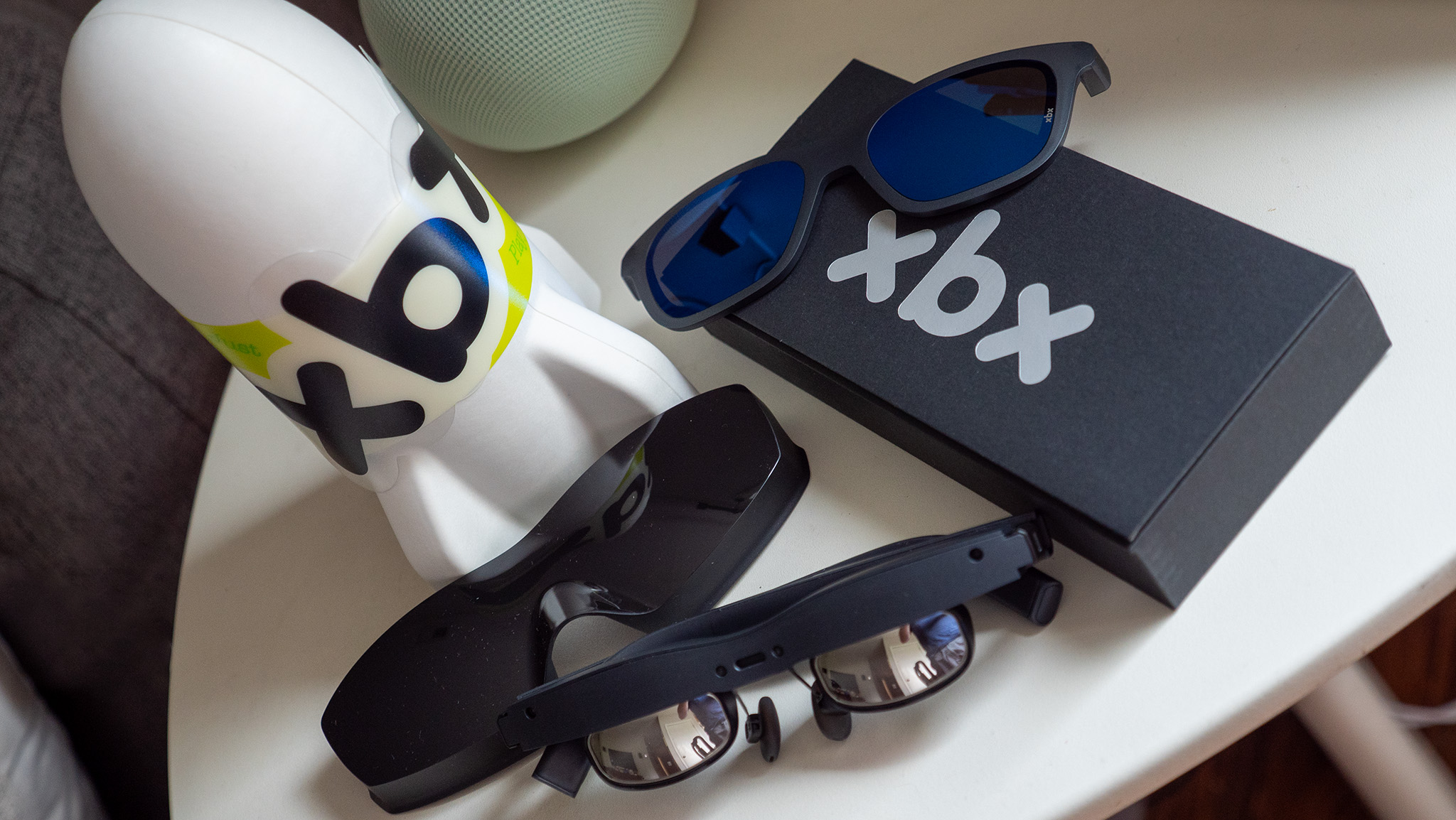 The X by Xreal box, its contents, and an optional XBX lens shade accessory