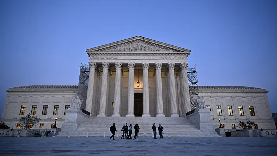 People walk past the US Supreme Court in Washington, DC
