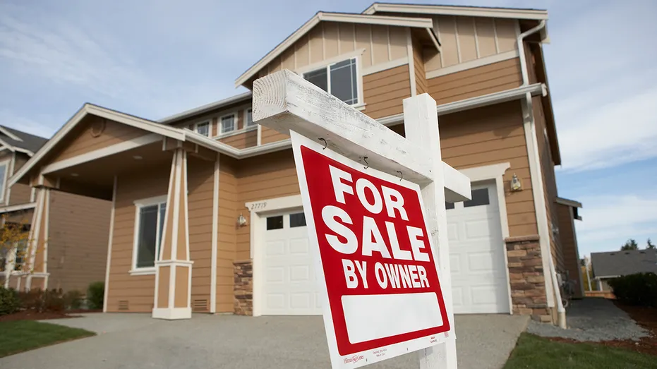 Home with for sale sign in front yard