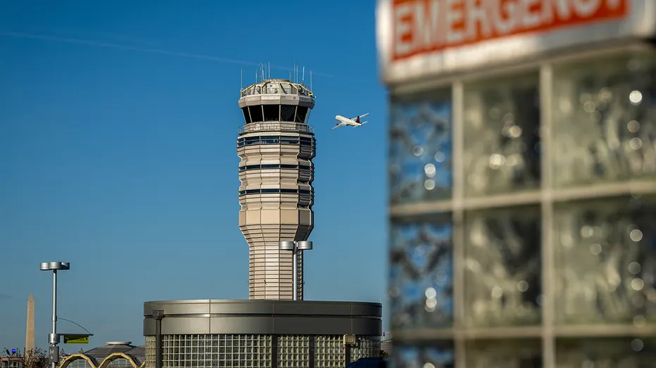 Air traffic control tower with plane in background