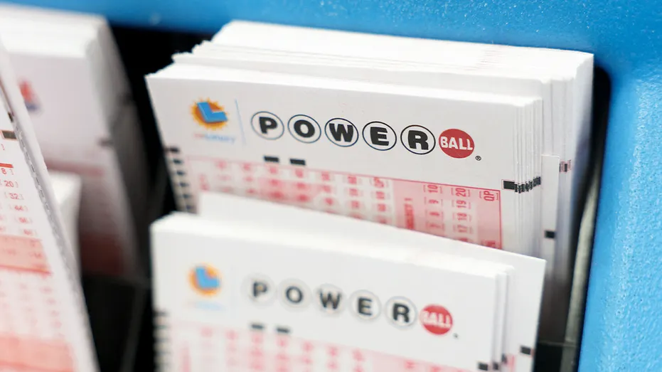 Stacks of blank Powerball playslips arranged at a lottery counter in a well-known California liquor store.