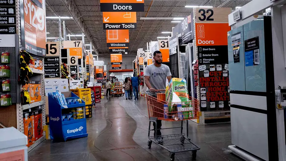 Customers shop at a Home Depot store on August 19, 2025 in Chicago, Illinois.