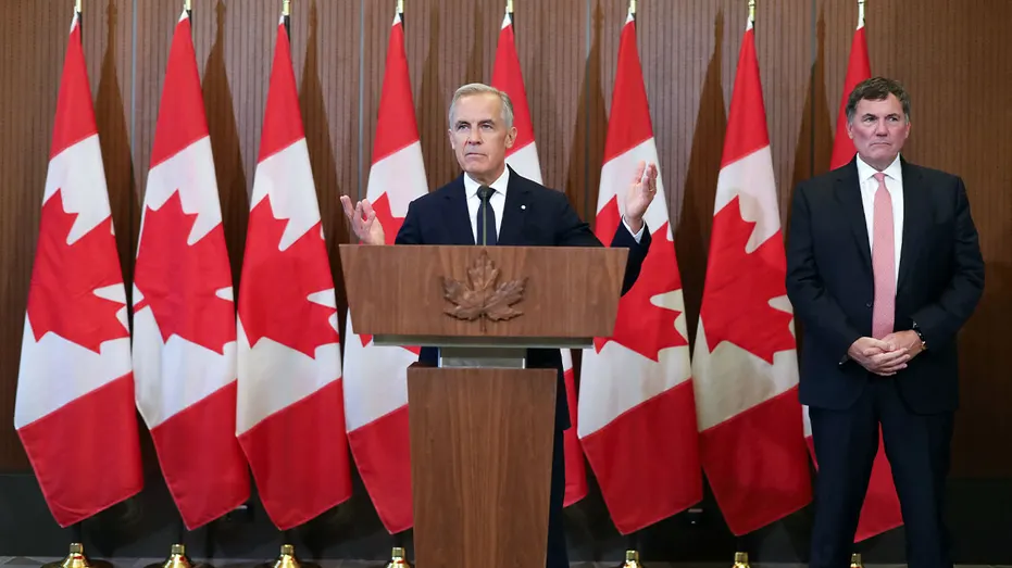 Canadian Prime Minister Mark Carney speaks at a podium during a news conference on U.S.-Canada trade negotiations