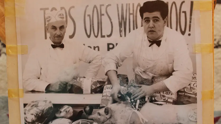Meatcutter stands at Tops Market counter in 1963.