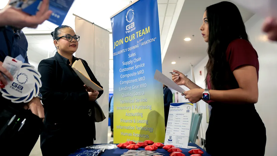 People at a table during a job fair.
