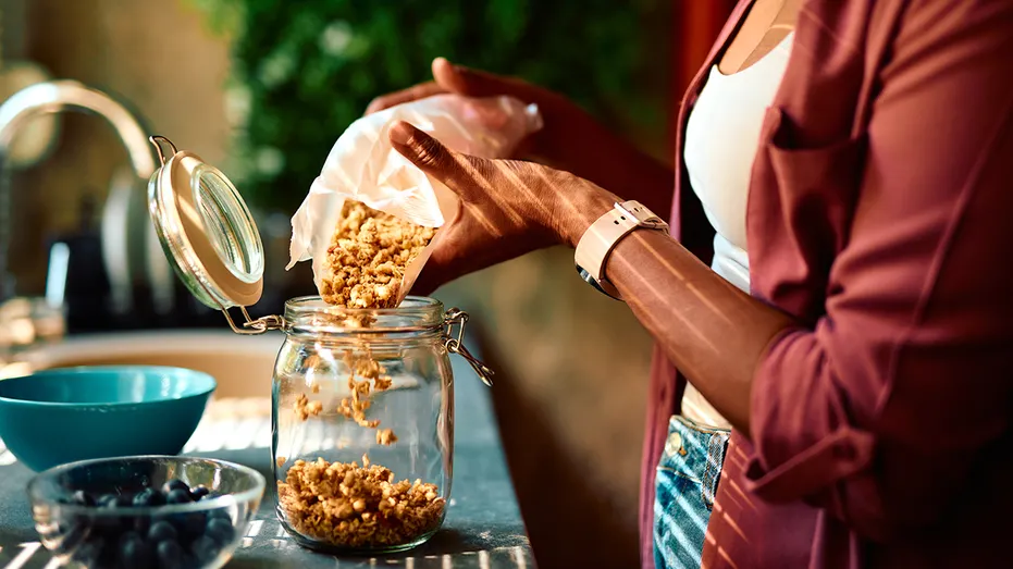 Woman pouring granola