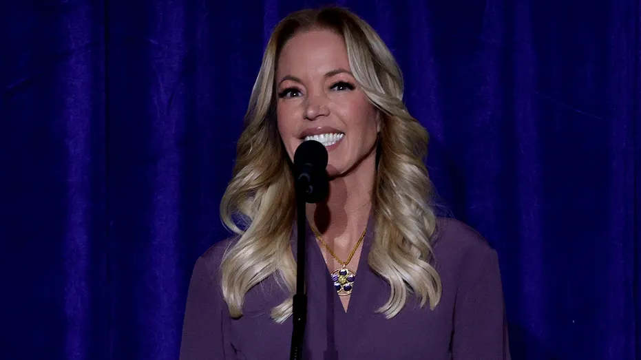 Jeanie Buss smiles at microphone