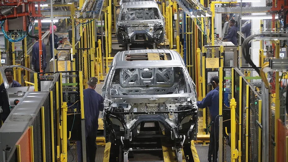 Workers assemble Ford vehicles at the Chicago Assembly Plant
