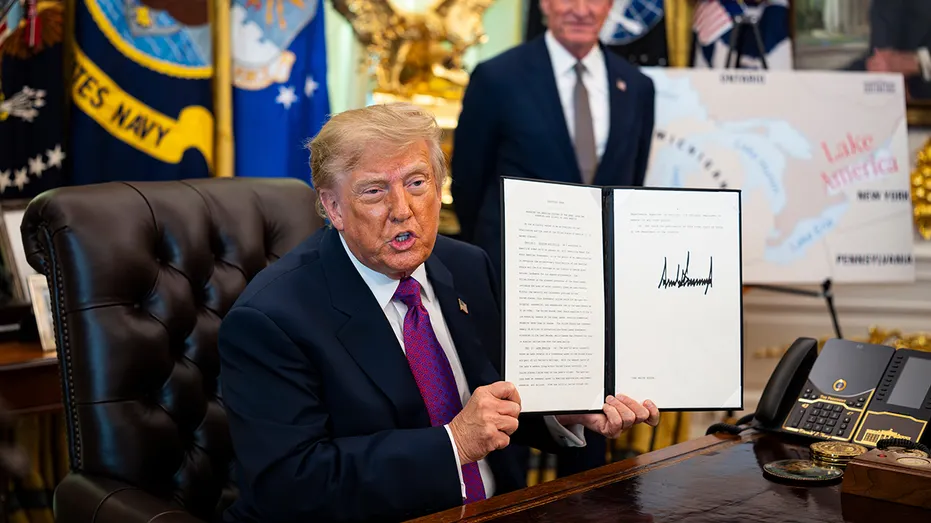 US President Donald Trump displays a signed executive order