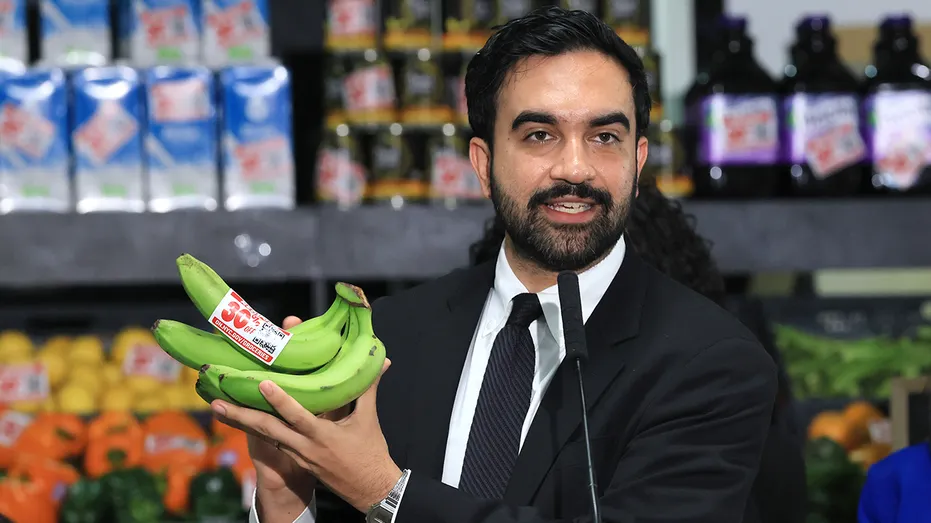 New York City Mayor Zohran Mamdani holds up a bunch of bananas