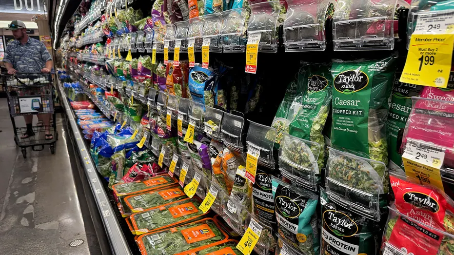 Packages of Taylor Farms salad greens displayed on shelves at a Safeway grocery store in California