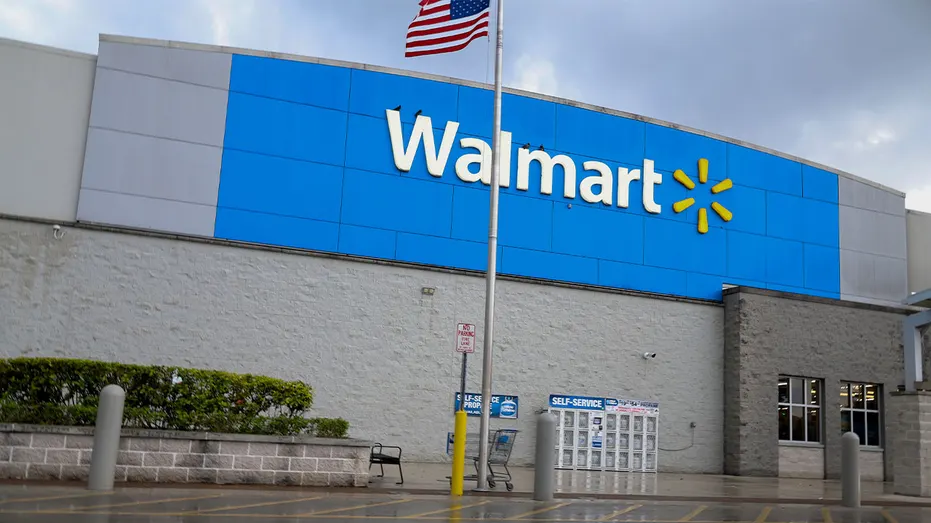 Walmart store exterior with the retailer’s logo and an American flag outside the building