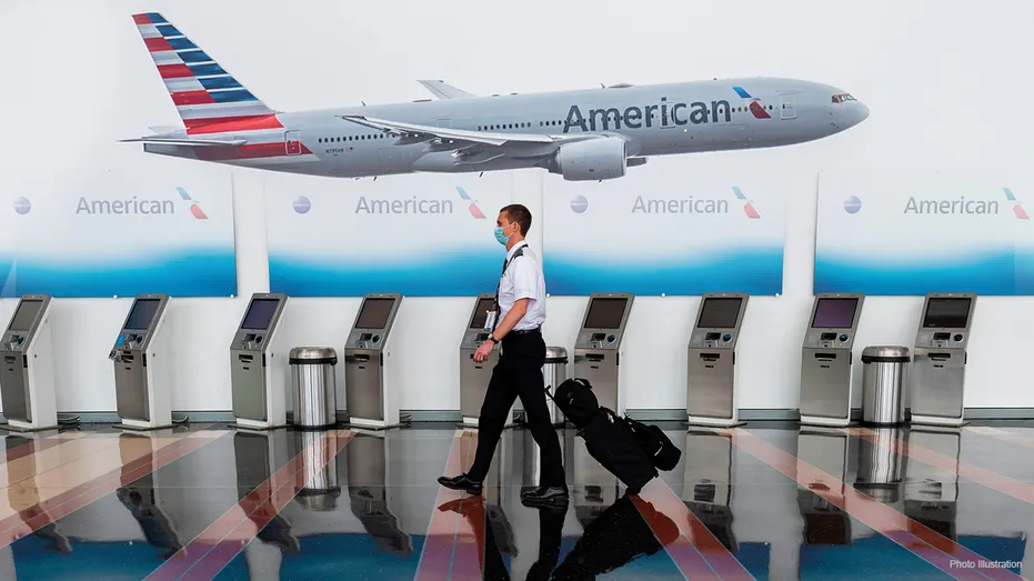 An American Airlines employees walks through an airport.