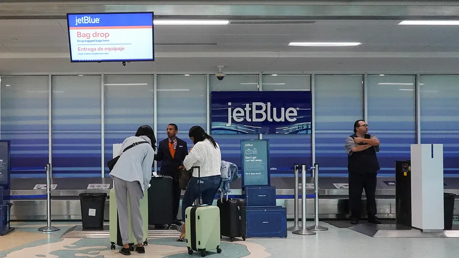 People check in their bags at the JetBlue Airways counter in the Fort Lauderdale-Hollywood International Airport