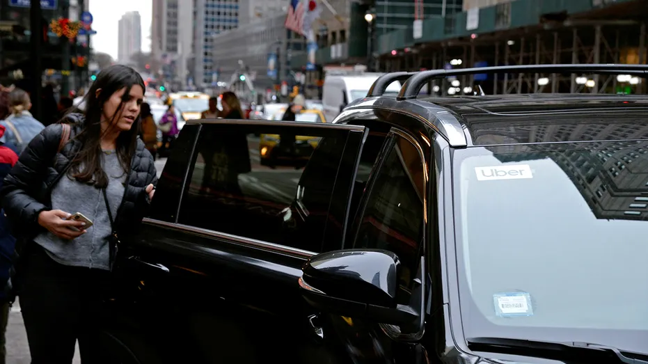 A passenger enters an Uber car