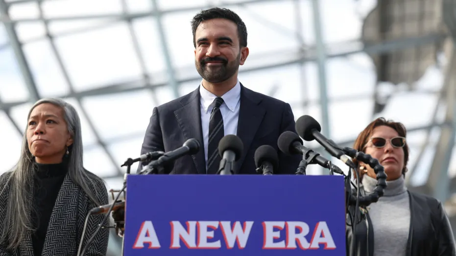 New York City Mayor-elect Zohran Mamdani speaks at a podium.