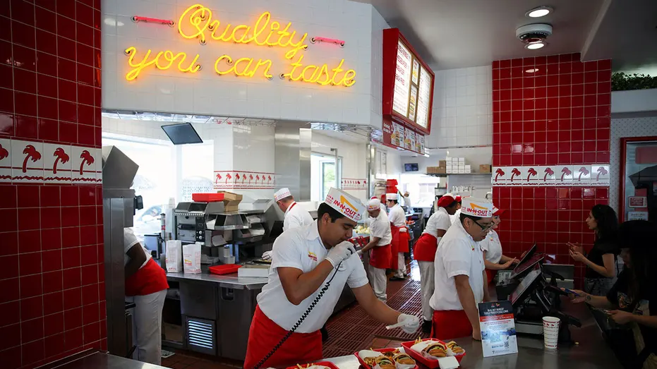 Workers serve customers at In-N-Out Burger outlet in Los Angeles