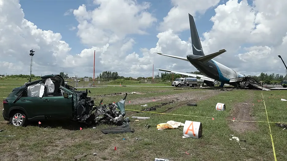 Damaged car near plane crash.