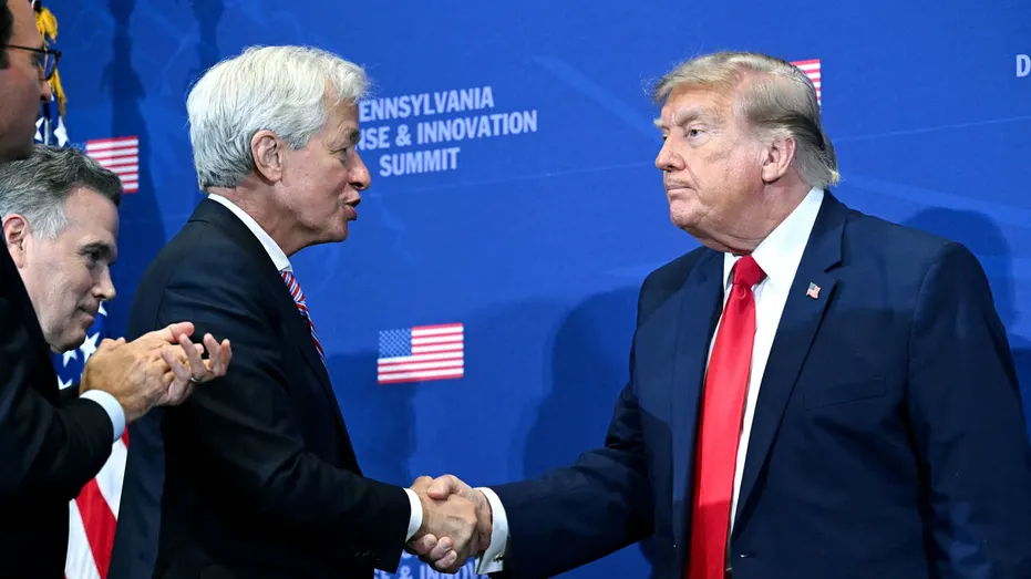 Jamie Dimon shakes hands with President Donald Trump.