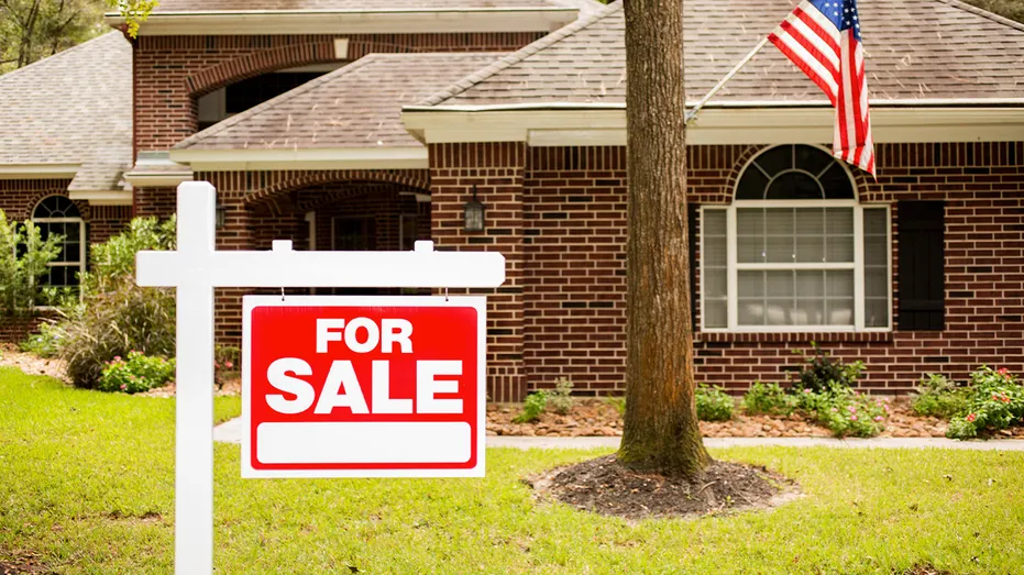 Home with a "for sale" sign