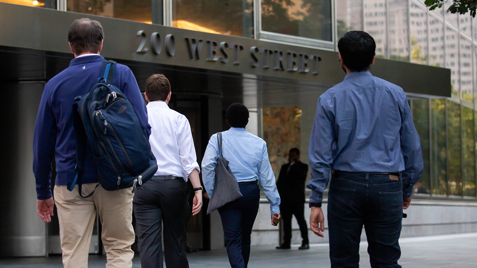 People walk toward an office building.
