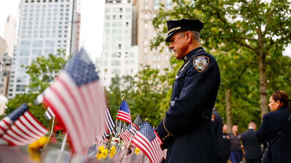 A police officer pays his respects at the 9/11 Memorial on Sept. 11, 2026.