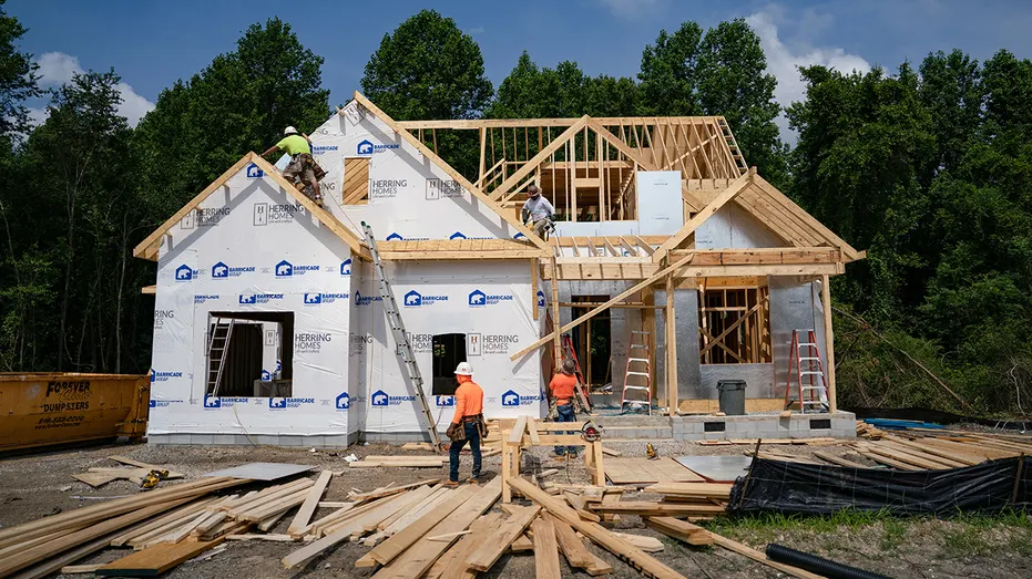 Workers build unfinished home
