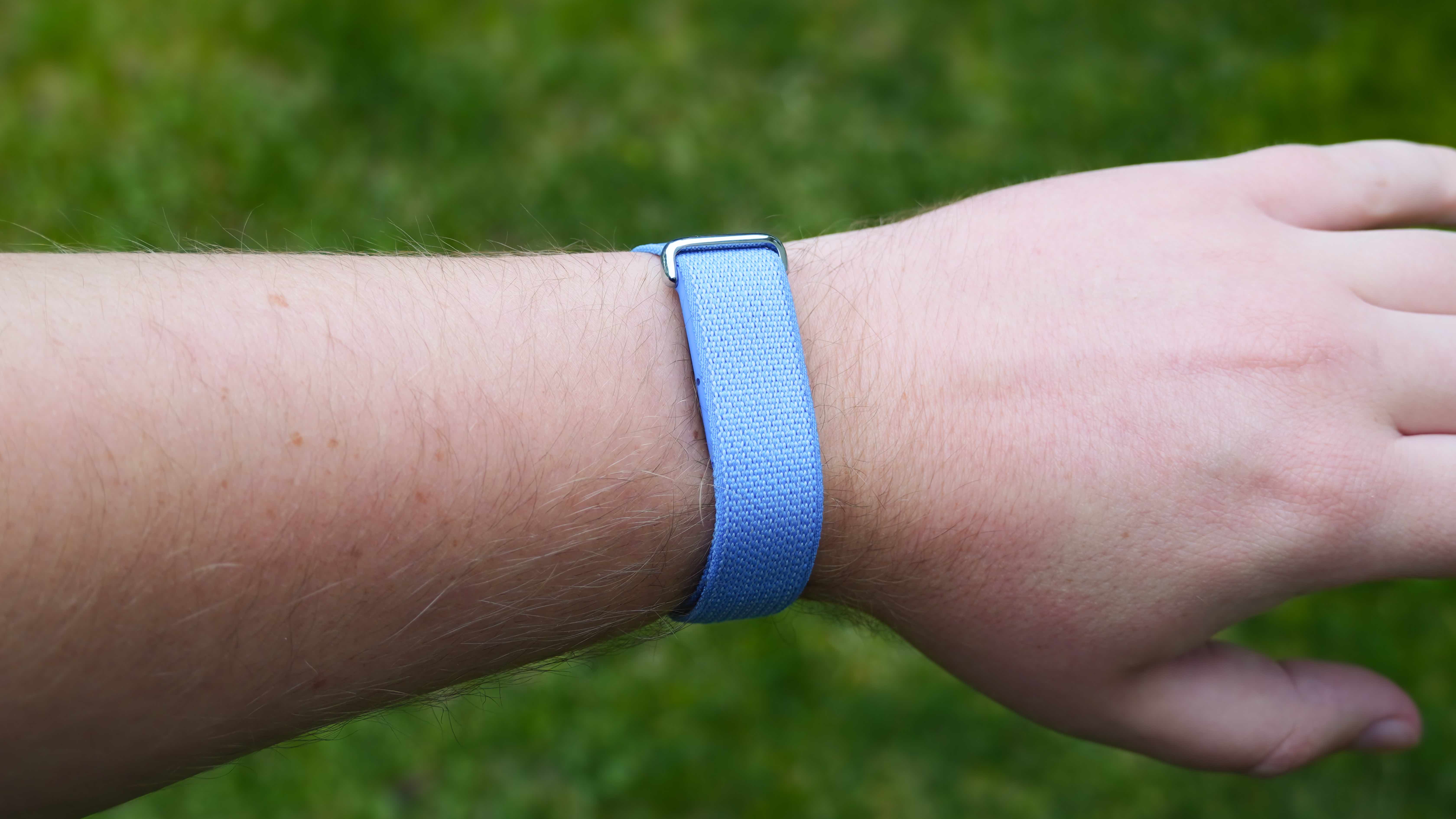 The Fitbit Air in a Lavender band and the Google Health app settings.