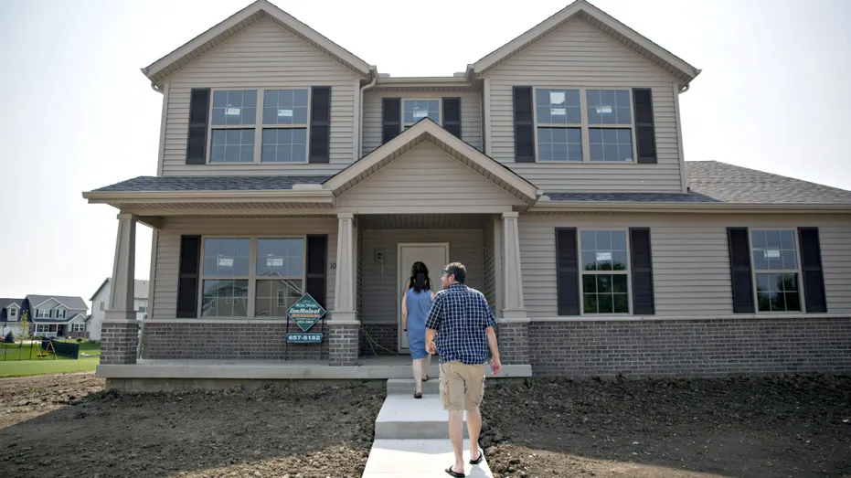 A couple tours a home.