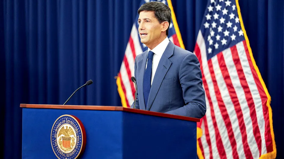 Kevin Warsh speaks from behind a podium.