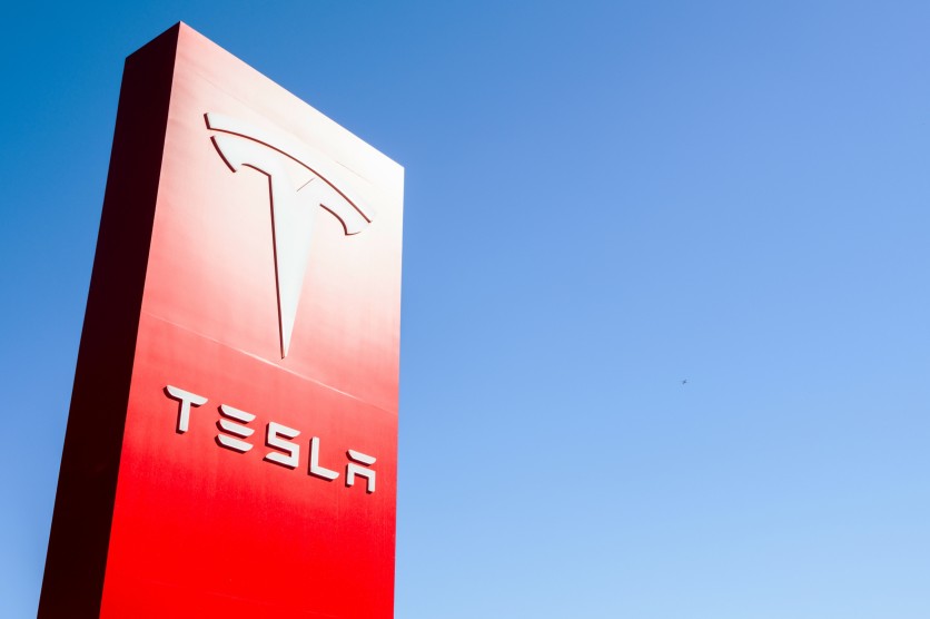 Tesla sign displayed dealership March 20 2025