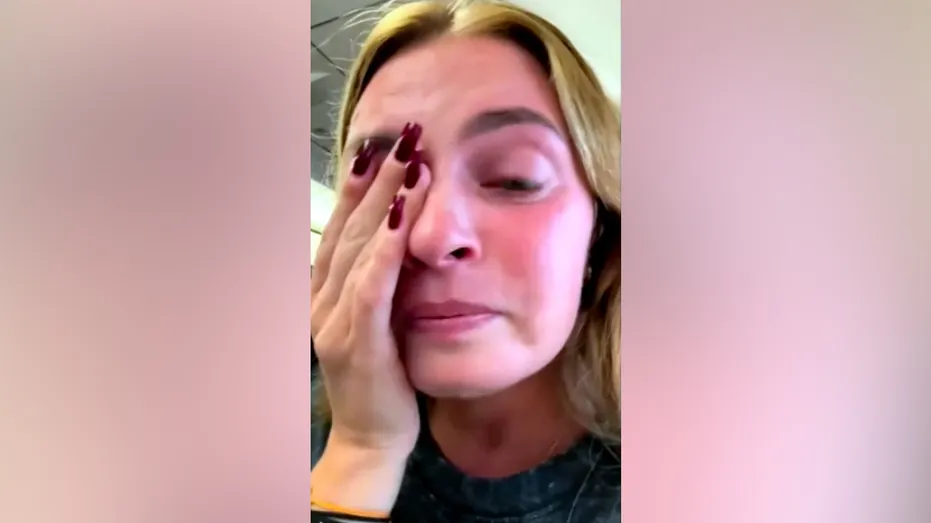 Marina Maiskaya wipes away tears aboard the plane
