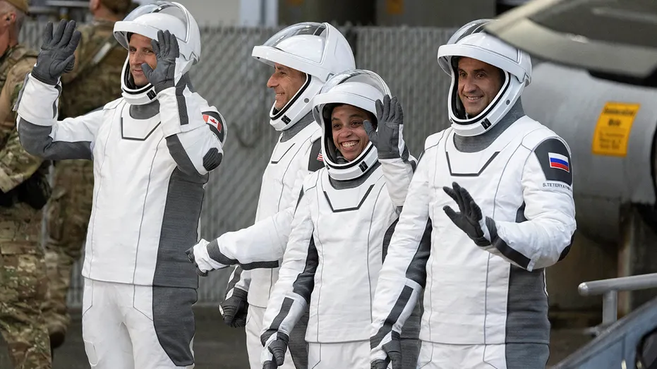 NASA SpaceX Crew-13 members gesture as they move to launch pad