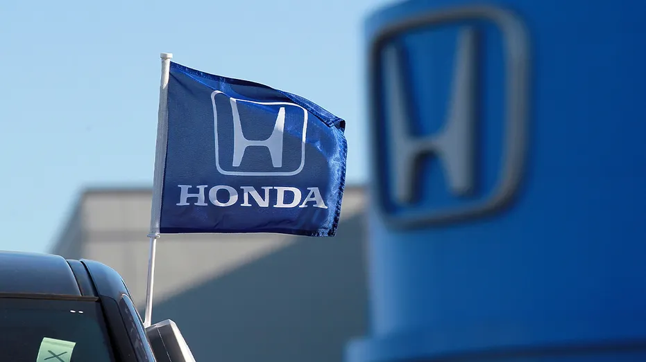 blue Honda flag near dealership