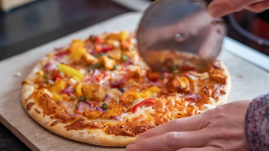 Slicing up a hot pizza