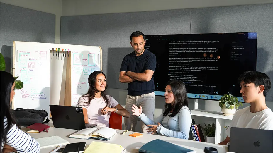 Gagan Biyani works alongside students during a group session at the Horowitz Andreessen Academy