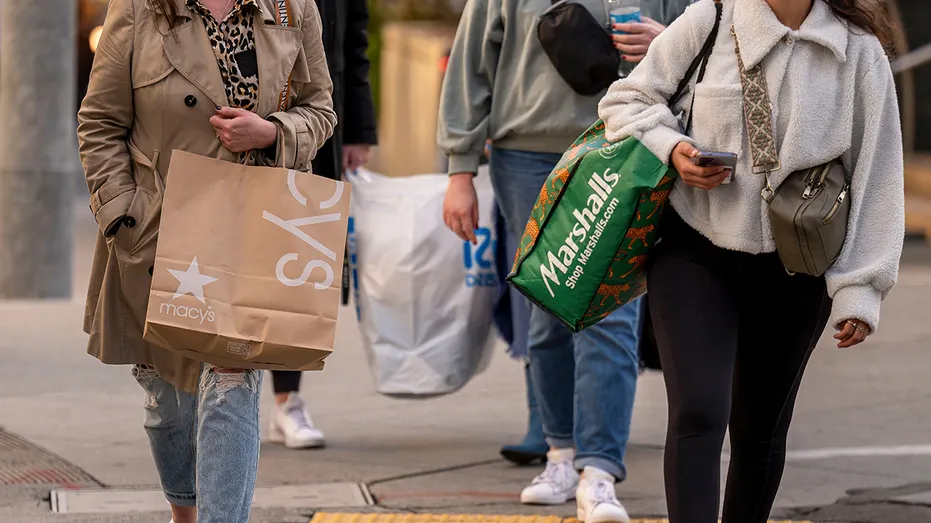 Shoppers carry Macy's, Marshalls, and Ross bags
