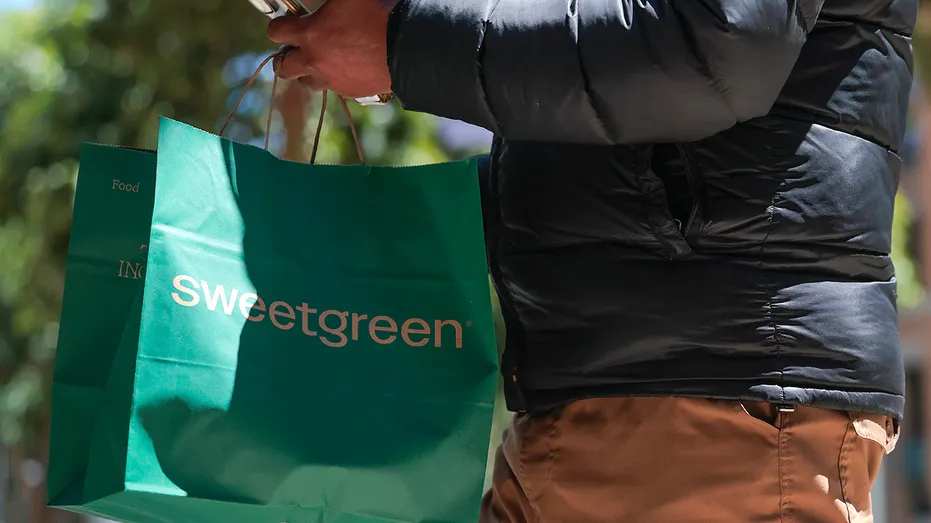 delivery driver walks out of a Sweetgreen restaurant
