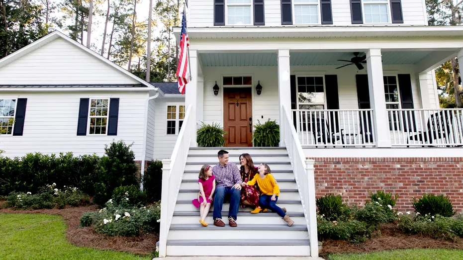 Family in front of house.