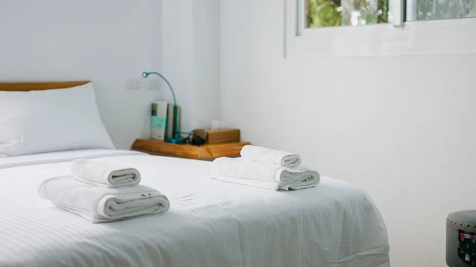 A neatly made bed inside a vacation rental bedroom