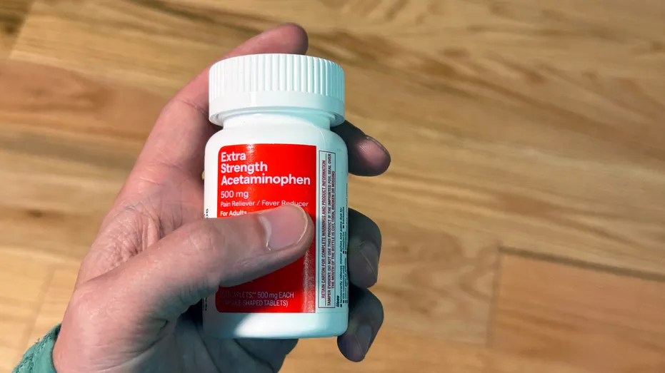 Hand Holding Acetaminophen Drug Bottle