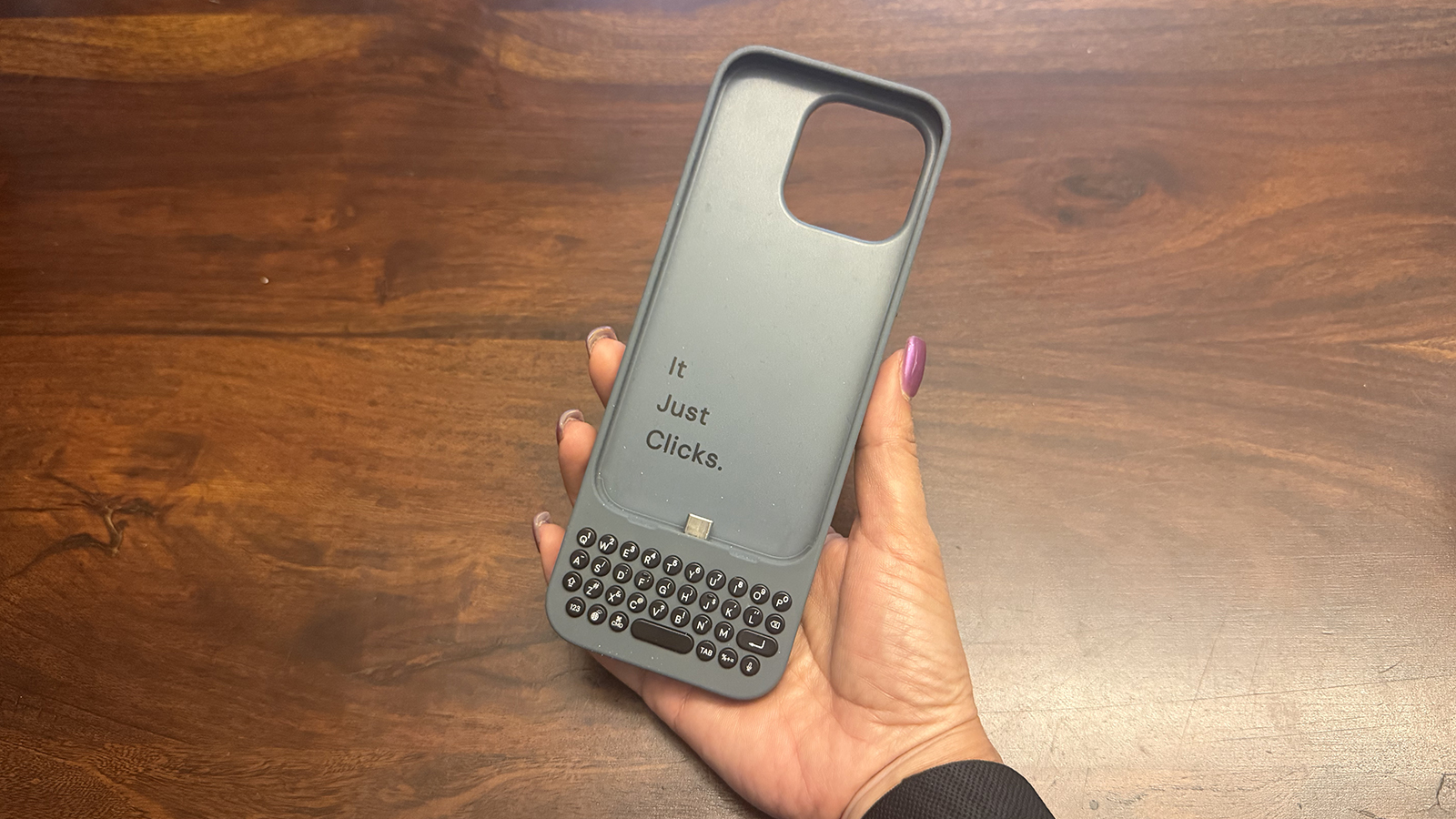 An original Clicks keyboard case in hand.