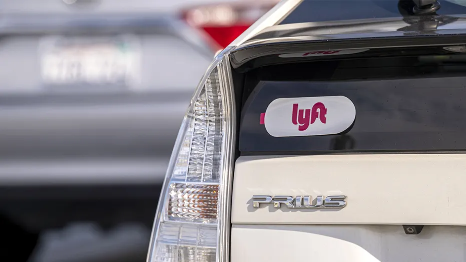 Lyft signage on a vehicle as it exits the ride-sharing pickup at San Francisco International Airport