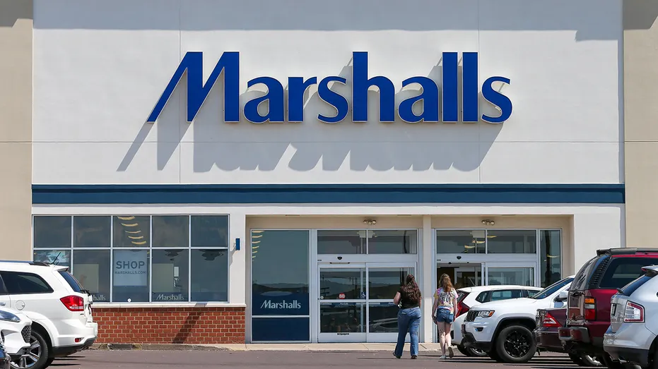 Shoppers are seen in the parking lot of a Marshalls store