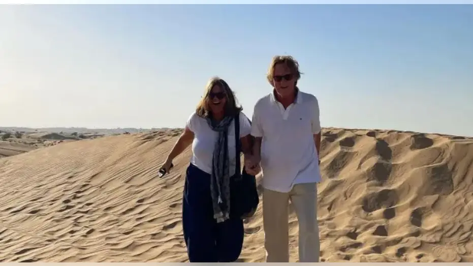 The Mortons walking in the sand